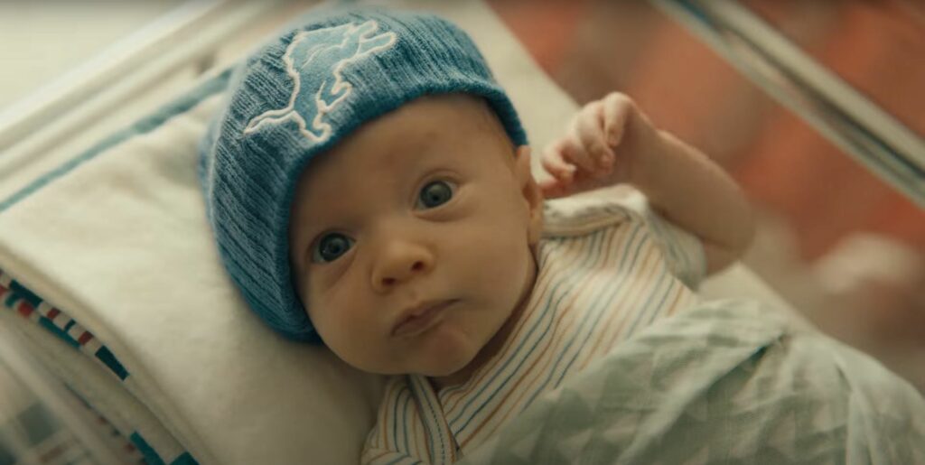 A baby wearing a blue beanie featured in a DirecTV NFL Sunday ticket commercial.