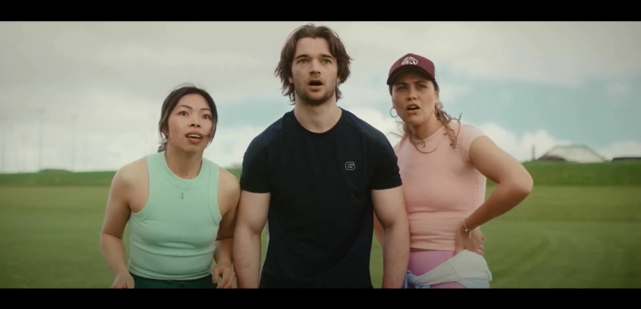 Three people standing next to each other in a field, representing Reel Factory's visionary advertising.