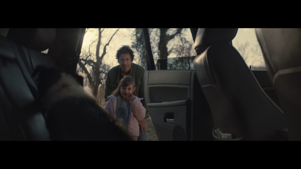 A sentimental woman and child on a road trip in a Jeep ad.
