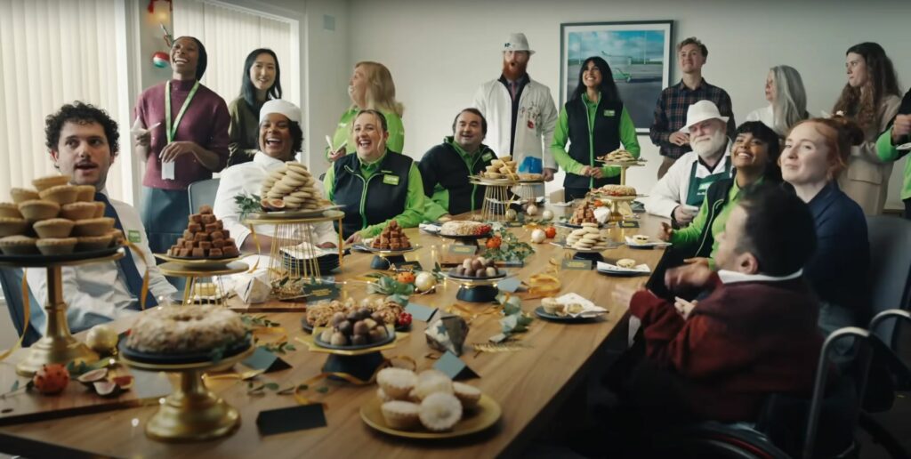 Asda Christmas Commercial 2023 featuring a group of people sitting around a table indulging in delicious desserts.