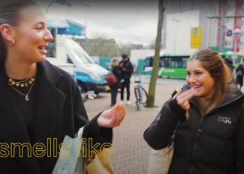 Two women having a conversation outdoors with overlay text that reads "it smells like McDonald's.