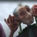 An animated giant with prominent ears and a playful expression, holding leafy vegetables like earrings against a cloudy sky, stars in Sainsbury's whimsical Christmas advert.