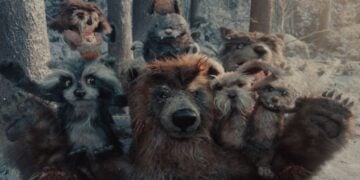 A group of animated forest animals, including a bear, raccoons, rabbits, and squirrels, pose together in a snowy, wooded environment inspired by the whimsical spirit of the Apple Holiday Ad 2025.